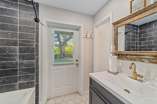 bathroom with tile patterned flooring, vanity, and tiled shower / bath combo