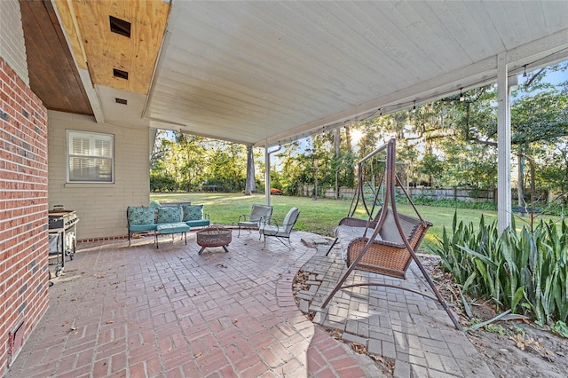 view of patio with an outdoor living space with a fire pit