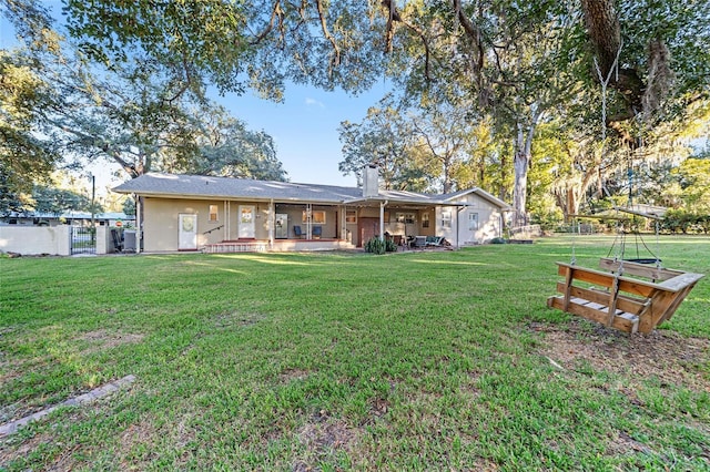 back of property featuring a lawn