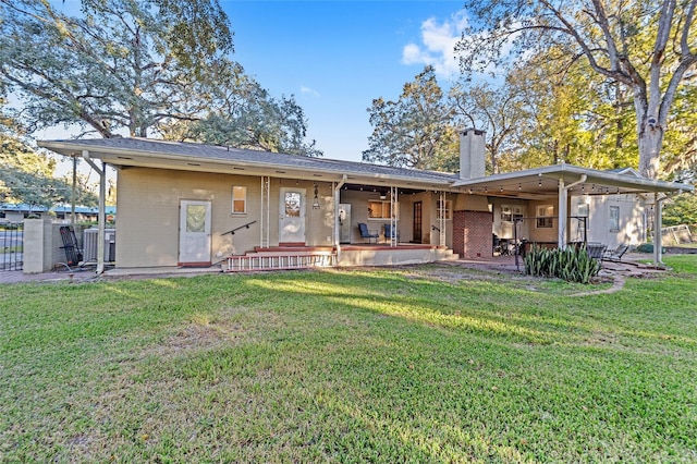 rear view of property featuring a yard and a patio