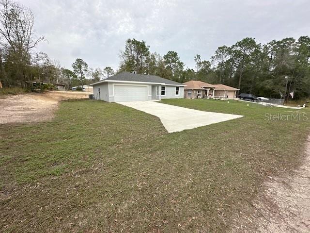 ranch-style house with concrete driveway, a front lawn, and an attached garage