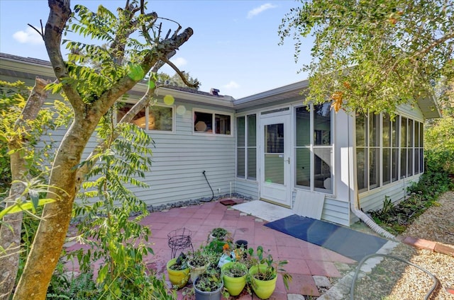 exterior space with a patio area and a sunroom