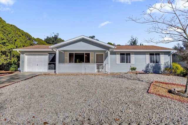 ranch-style house featuring a porch and a garage