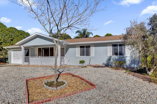 single story home with a porch and a garage