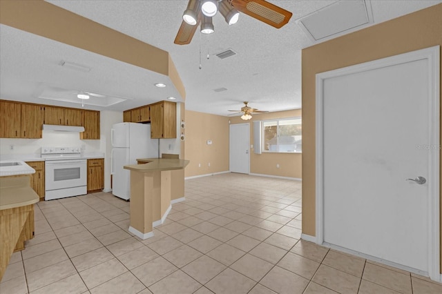 kitchen featuring a textured ceiling, white appliances, light tile patterned floors, and ceiling fan