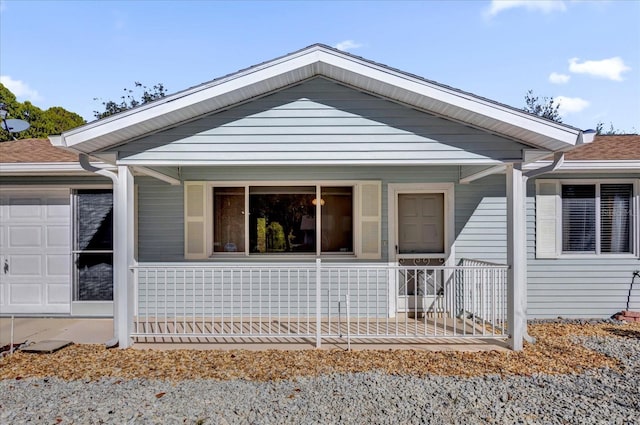 view of front facade featuring a porch and a garage