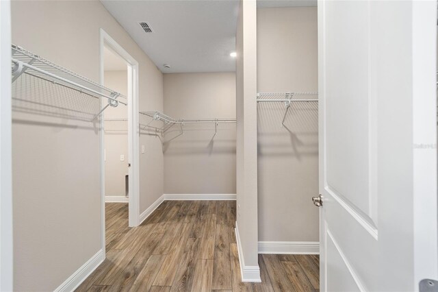 walk in closet featuring hardwood / wood-style floors