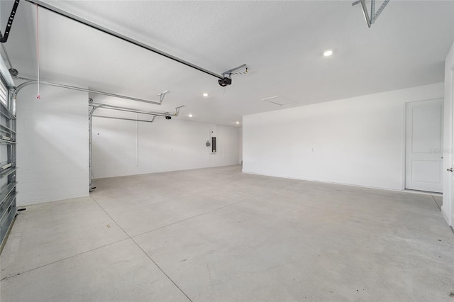 garage featuring electric panel and a garage door opener