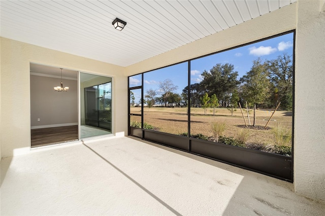 unfurnished sunroom featuring a notable chandelier