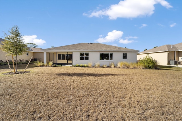 rear view of property with a yard and ac unit