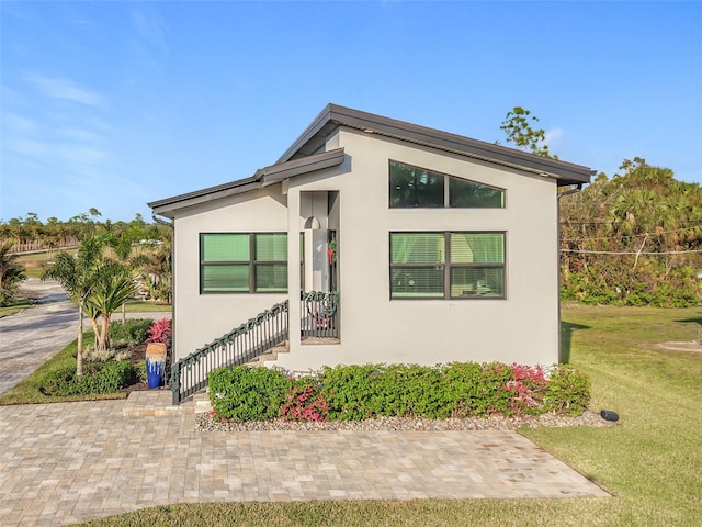 view of side of property with a lawn