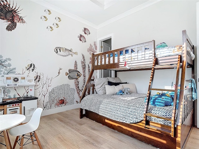 bedroom with ornamental molding and light wood-type flooring