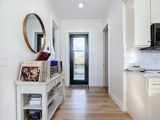 doorway with light hardwood / wood-style floors