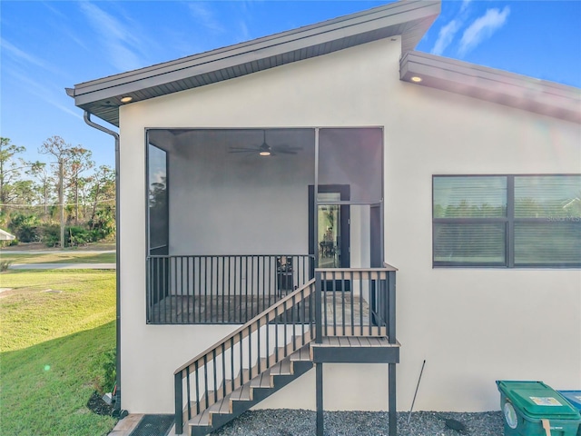 entrance to property with a lawn