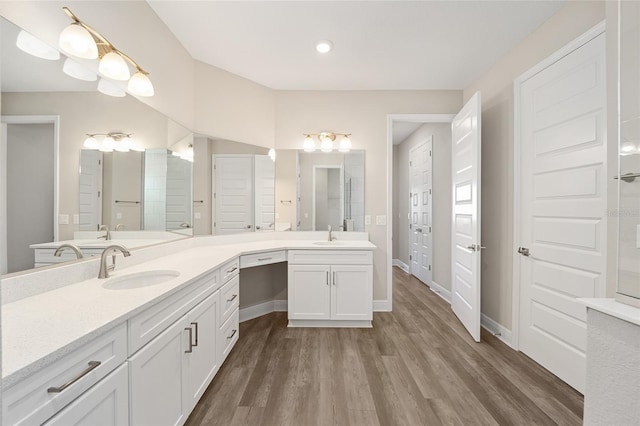 bathroom with hardwood / wood-style floors and vanity