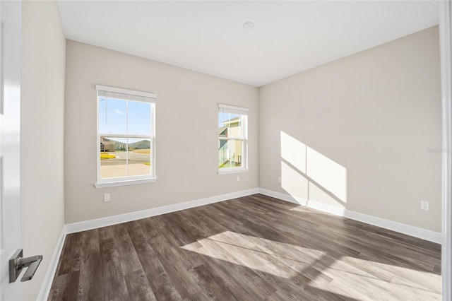 spare room featuring wood-type flooring