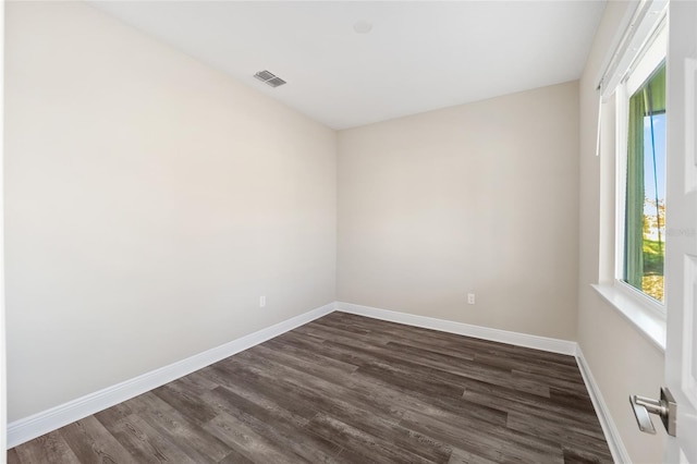 empty room with dark wood-type flooring