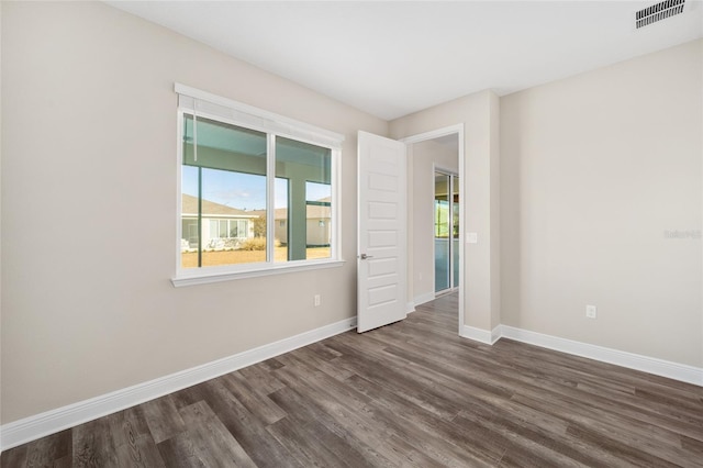 unfurnished room featuring dark hardwood / wood-style flooring