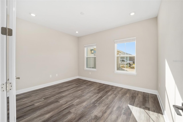 spare room with dark hardwood / wood-style floors