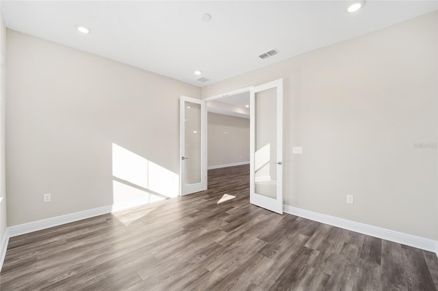 unfurnished room featuring french doors and dark wood-type flooring