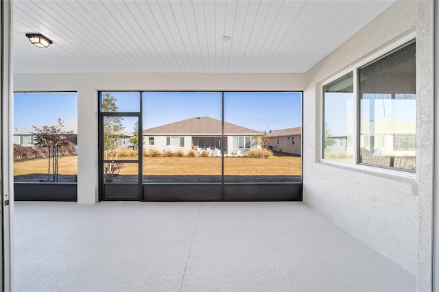 unfurnished sunroom with wood ceiling