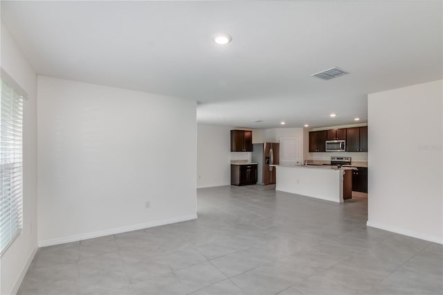 unfurnished living room featuring light tile patterned floors