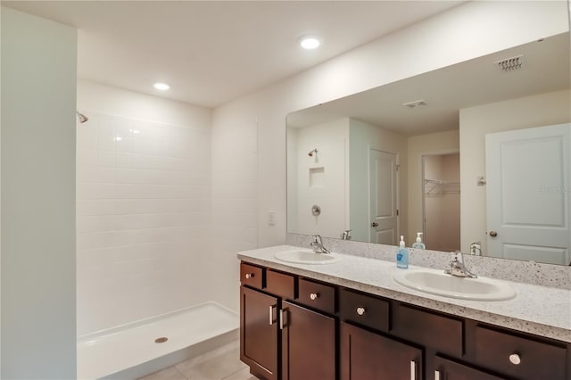 bathroom with vanity, tile patterned floors, and walk in shower