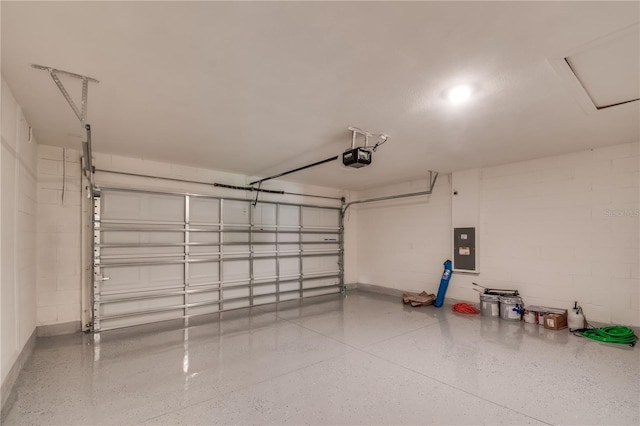 garage with a garage door opener and electric panel