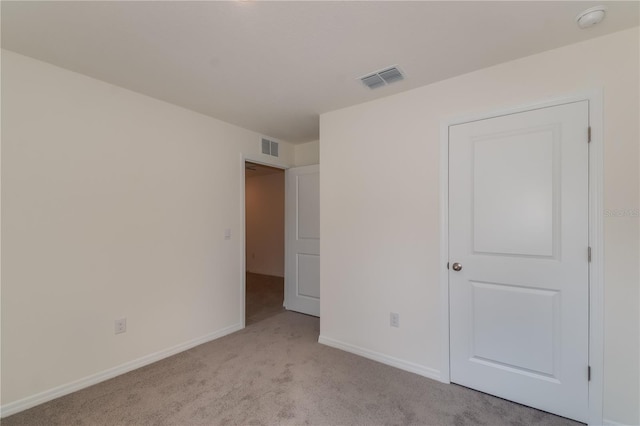 unfurnished bedroom with light colored carpet