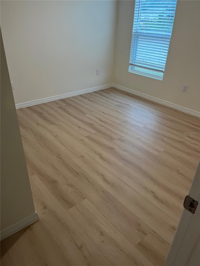 spare room with light hardwood / wood-style floors