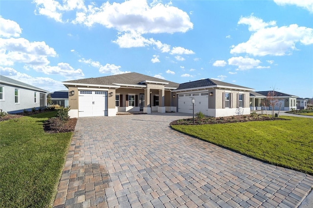 prairie-style home featuring a front yard and a garage