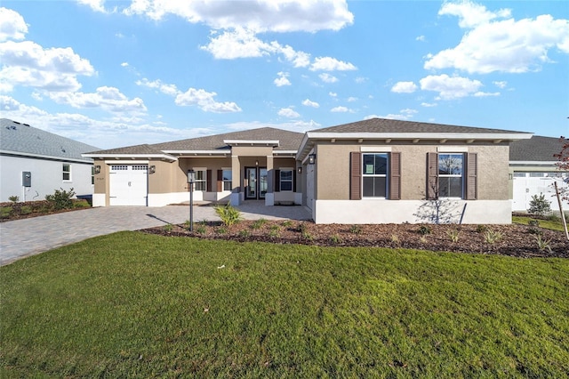 prairie-style home with a garage and a front lawn