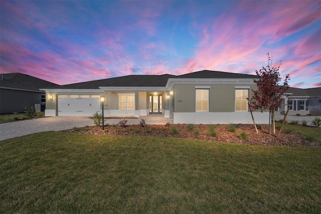 view of front of house with a lawn and a garage