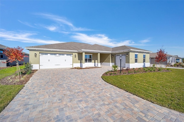 view of front of home with a garage and a front yard