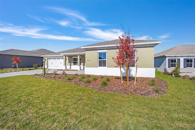 ranch-style house featuring a garage and a front lawn