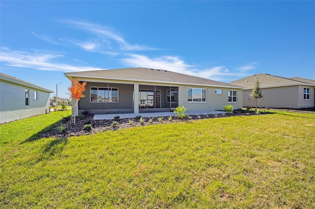 rear view of property with a lawn