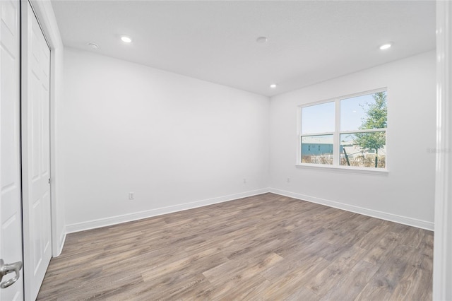 unfurnished bedroom with a closet and hardwood / wood-style flooring