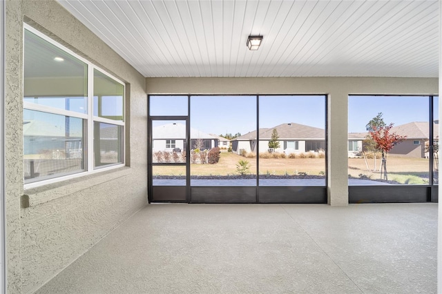 unfurnished sunroom featuring a wealth of natural light