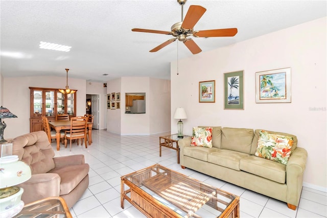 tiled living room featuring a textured ceiling, ceiling fan, and vaulted ceiling