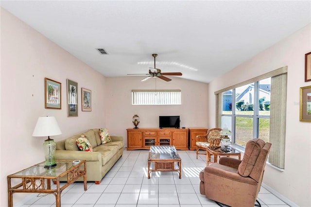 tiled living room with ceiling fan and lofted ceiling