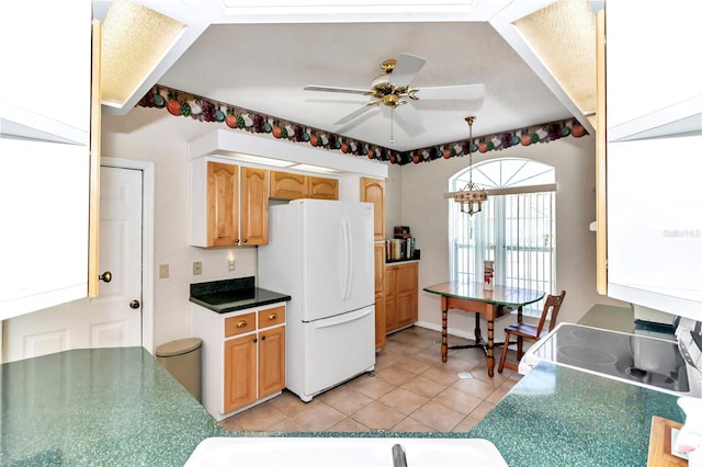 kitchen featuring french doors, ceiling fan, white refrigerator, hanging light fixtures, and light tile patterned flooring