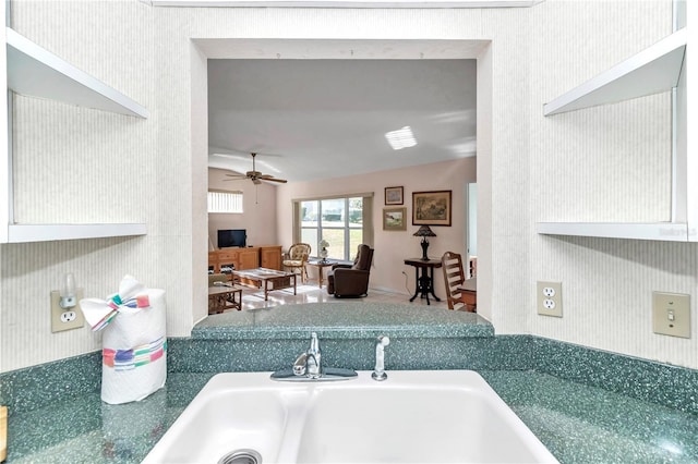 kitchen featuring ceiling fan and sink