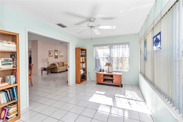 interior space with ceiling fan