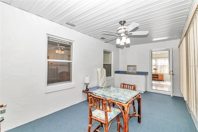 dining room featuring dark colored carpet and ceiling fan