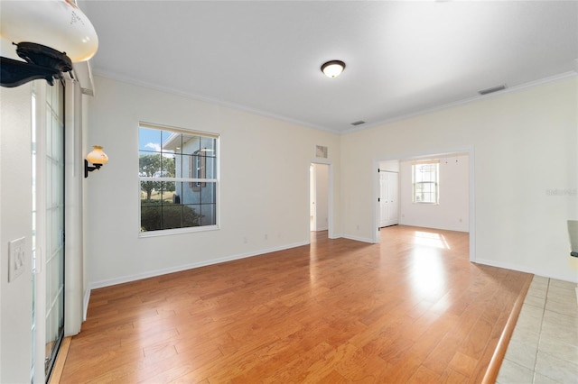 unfurnished room with light wood-type flooring and ornamental molding