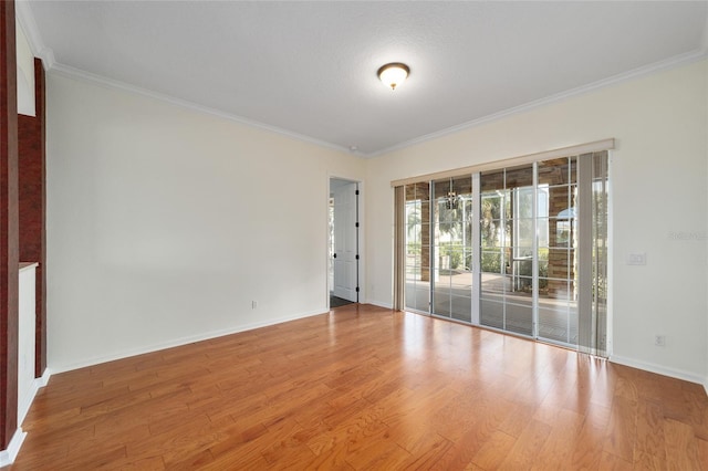 spare room with hardwood / wood-style floors, a textured ceiling, and ornamental molding