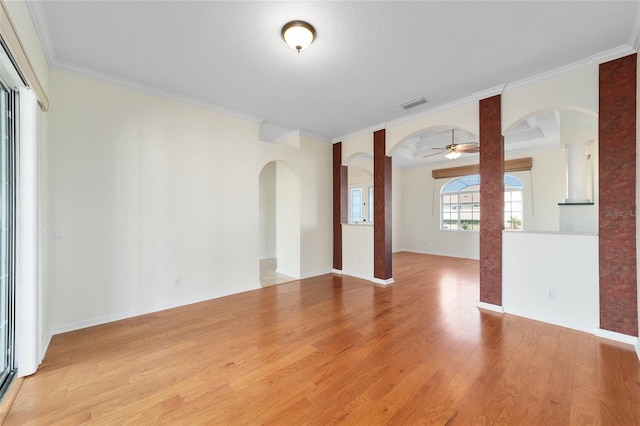 spare room with ceiling fan, light hardwood / wood-style floors, and crown molding