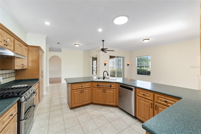 kitchen with appliances with stainless steel finishes, tasteful backsplash, ceiling fan, sink, and light tile patterned floors