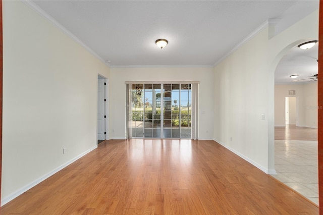 spare room with light hardwood / wood-style floors, ceiling fan, and ornamental molding