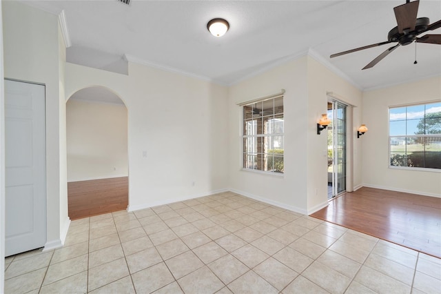 spare room featuring light hardwood / wood-style flooring, ceiling fan, and ornamental molding